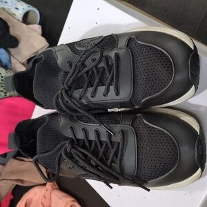 Black gym shoe with fake leather accents